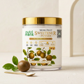 A jar of Nutri Monk Sweetener Powder with a gold lid and white label, styled on a light beige surface with a gold spoon and a real monk fruit and leaf in the foreground.