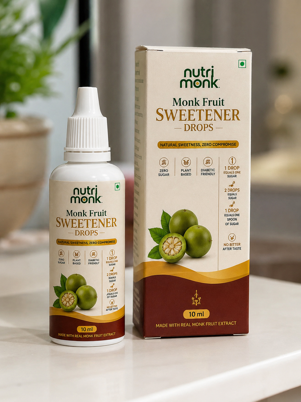 A bottle and box of nutri monk Monk Fruit Sweetener Drops displayed on a white surface with a blurred indoor background.